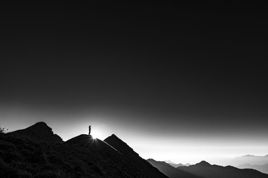 Mountaineer on summit ridge with backlight, in the background Ammergau Alps, Reutte, Ammergau Alps, Tyrol, Austria