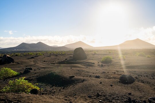 Large round volcanic stone Bomba volc&aacute;nica Gude, volcanic landscape with lava fields, Parque Natural de Los Volcanes, Lanzarote, Canary Islands, Spain