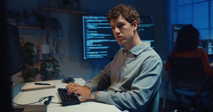 Group Adult male, female freelance typing write prompt AI bot IT app smart program nomad, video game, terminal with coding language, designer, big data center on desktop computer in office at night.