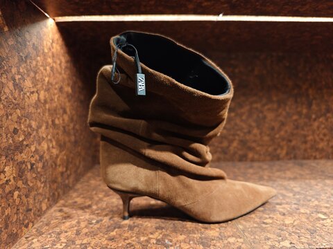 Shanghai, China-Jan.10th 2026: ZARA brown suede pointed-toe kitten heel boot with brand tag in store