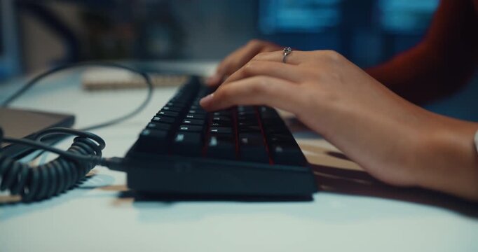 Close-up Black female programmer typing coding on keyboard working late in home office at night. Cybersecurity, AI algorithm, Network security, software developer, remote workspace overtime concept.