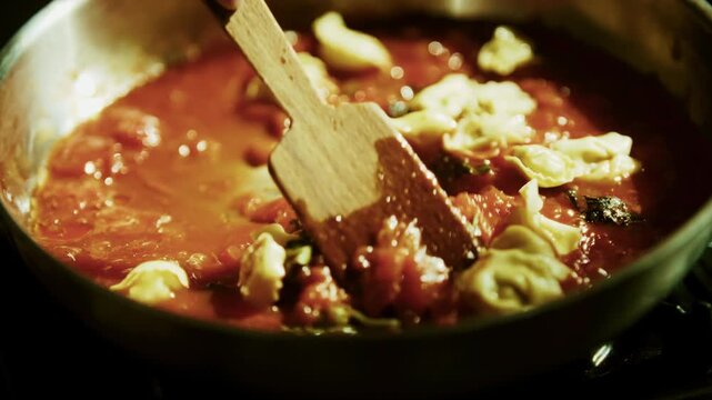 Fresh Italian Tortellini Pasta Cooking In Boiling Tomato Sauce. Dish Italian Preparation 