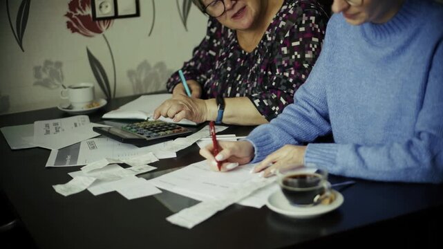 Two Accountants Calculating Budget Expenses With Financial Receipts Calculator Bills. Management Economy