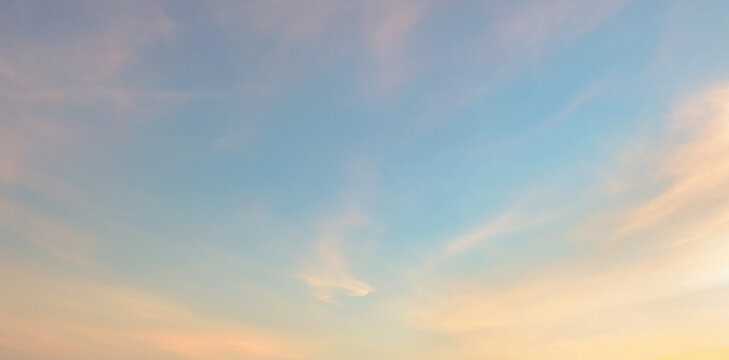 Soft clouds drift across a gentle twilight sky