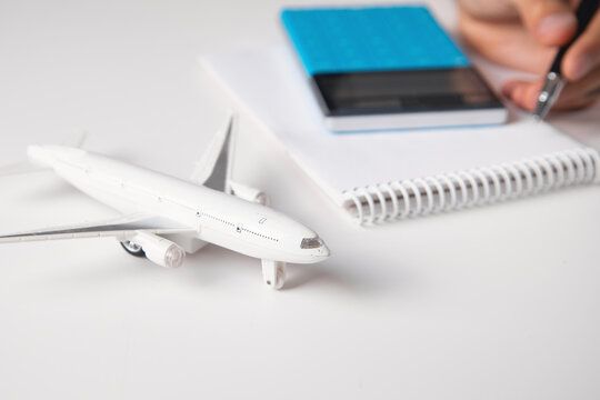 Man working in office with a toy airplane and other objects.