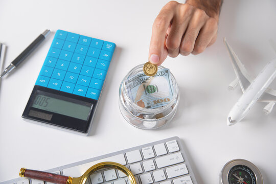 Man working in office with a toy airplane and other objects.