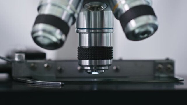 Extreme close-up of a sample being examined under a microscope lenses