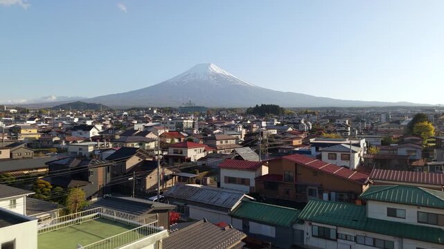 Aerial view of Mount Fuji towering over Fujiyoshida city in Yamanashi, Japan.