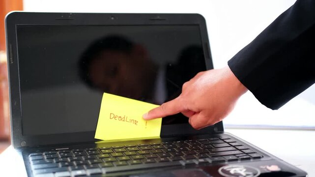 An employee's hand is pointing at a notice reading "On Leave" on a laptop screen&mdash;taking time off, a break from work, or a vacation.
