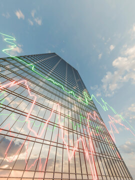 Low angle view of a modern glass skyscraper with glowing financial market trend line charts
