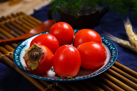Ripe Fresh Red Persimmons On Wooden Serving Tray