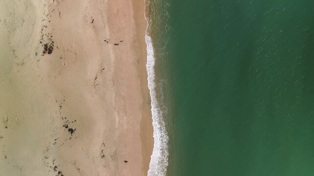 Aerial view of the sandy beach and turquoise sea at Carlyon Bay, Cornwall, United Kingdom.