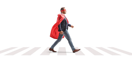Full length profile shot of a superhero businessman walking at pedestrian crossing © Ljupco Smokovski