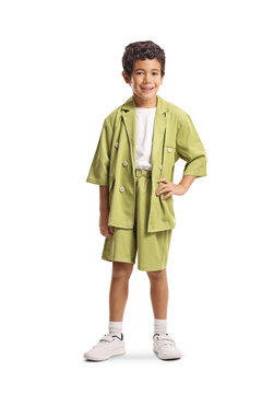 Boy in a trendy green suit posing with hand on hip
