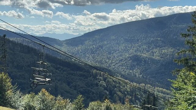 Open ski lift carrying a bicycle to downhill tracks on Mosorny Gron mountain, Zawoja
