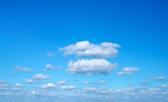 Blue sky background with tiny clouds