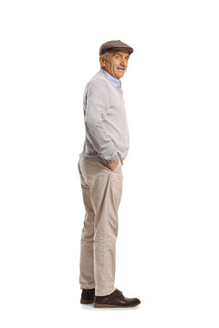 Elderly man wearing a flat cap and sweater standing in profile
