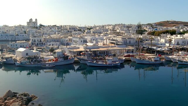 Aerial view of traditional fishing boats docked in the picturesque harbor of Naoussa, Greece.