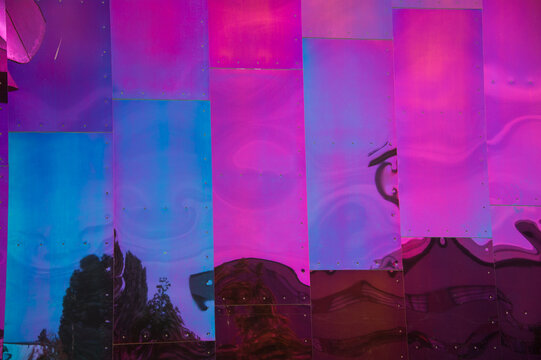 View of the iridescent and reflective metal facade of the Museum of Pop Culture with abstract distortions in Seattle, Washington, United States.