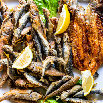 assortment of local fried fishes close-up on plate