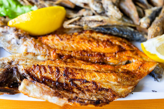 fried dorade fish close-up on fish plate