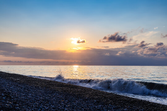 dark blue sky and sea water sunlit by setting sun