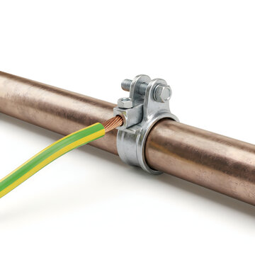 Metal grounding clamp attached to a copper pipe