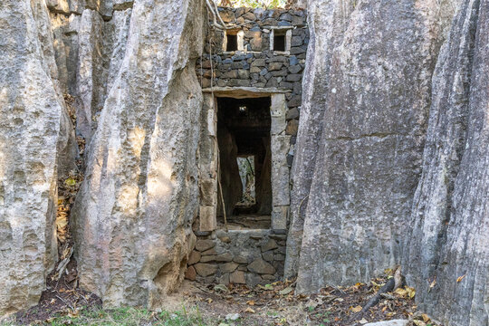 Stone ruin doorway amid limestone pinnacles, Petit Tsingy, Madagascar
