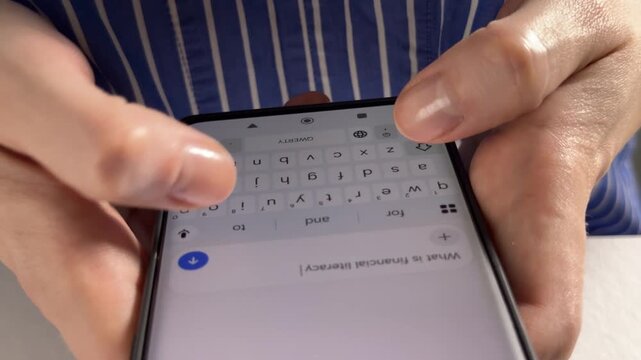 User inputting a text prompt into an artificial intelligence chatbot application online. Human hands typing on a smartphone keyboard to communicate with automated generative assistant model.