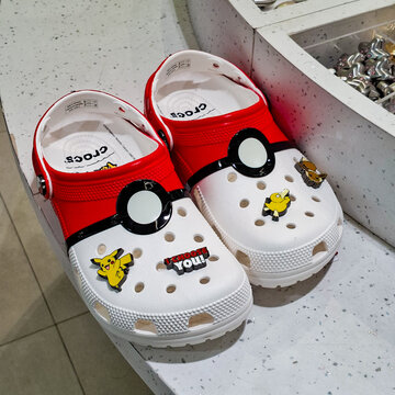 Red and white Pokeball Pokemon Crocs clogs decorated with Pikachu Psyduck Eevee shoe charms Jibbitz on September 27, 2026 in Bangkok, Thailand.
