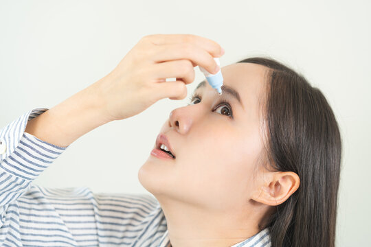 Health care concept, eye problem asian young woman applying, using medical eye drops to treat dry eye and irritation, suffering from irritated eye dry eyes or inflammation, allergy optical symptom.