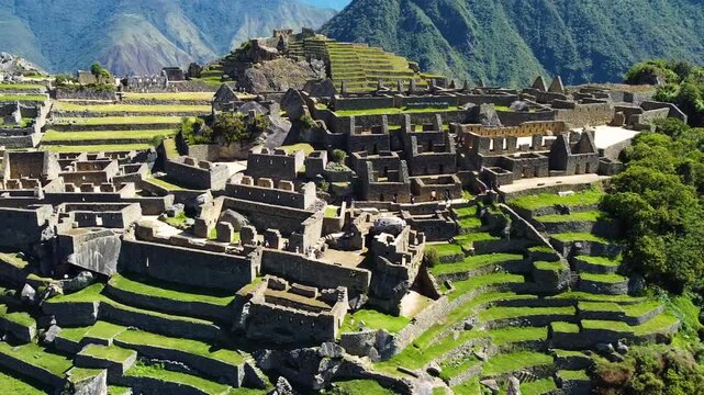 Aerial view of the ancient stone ruins and agricultural terraces of the Historic Sanctuary of Machu Picchu in Urubamba Province, Cusco, Peru.