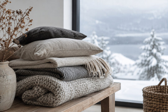 Photorealistic winter stock photo of a stack of folded wool blankets