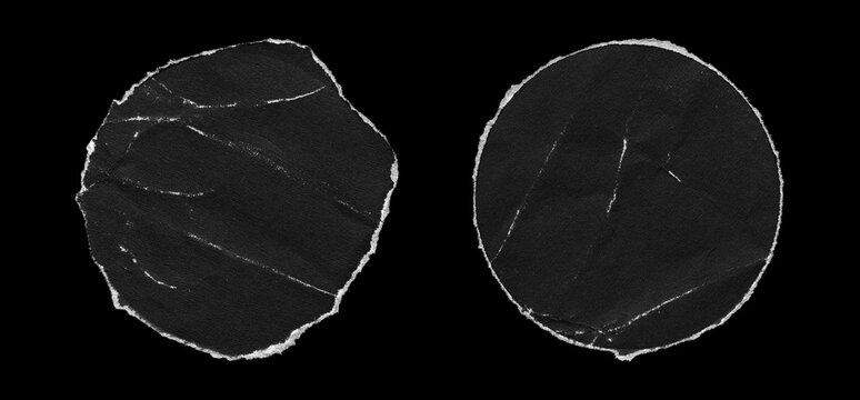 Set of two round black torn paper cutouts with irregular ripped white edges, subtle wrinkles, crease lines, matte surface grain, and varied circular shapes on black background