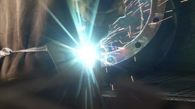 Welding of steels with Mig welding, flange nozzle welding master. Welder working on flange for new line manufacturing