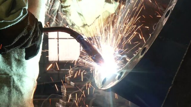 Welding of steels with Mig welding, flange nozzle welding master. Welder working on flange for new line manufacturing
