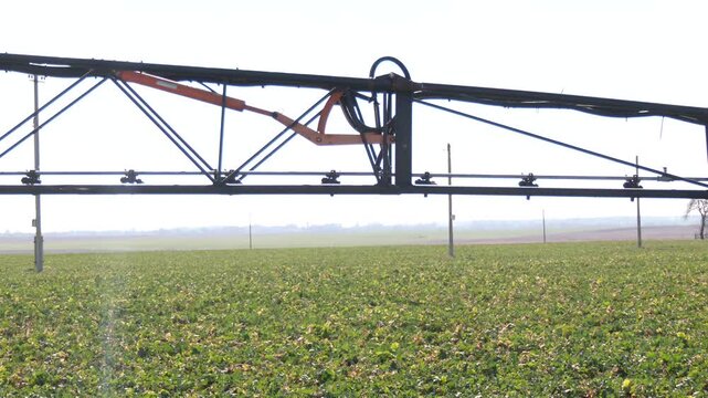Modern agricultural technologies. Industrial production of agricultural crops. Close-up of an automatic irrigation system in a field. Equipment for industrial irrigation