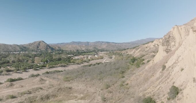 Aerial view of an eroded bluff above a dry riverbed