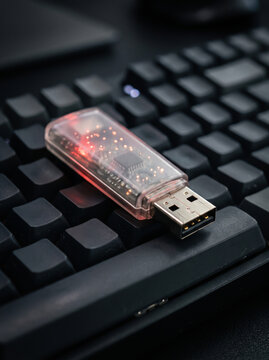 Transparent usb flash drive on black keyboard technology and data storage concept