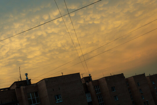 Sky at Dusk Over Buildings With Soft Clouds and Power Lines