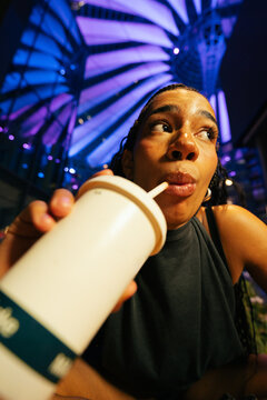 Woman Sipping Milkshake at Night
