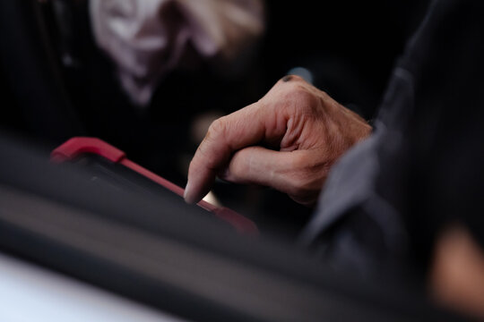Mechanic Using Diagnostic Tablet