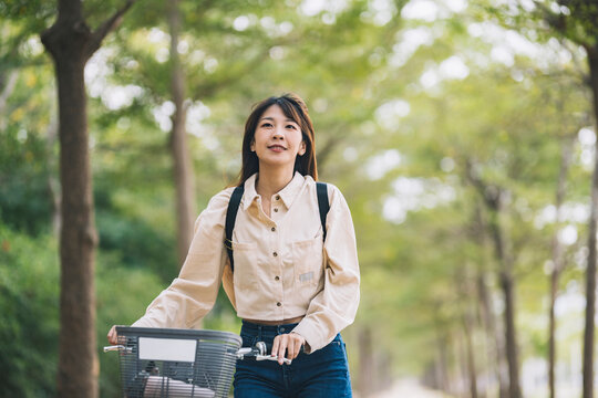 Asian woman renting shared bicycle in city