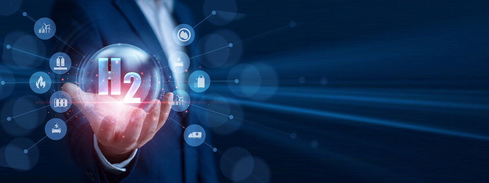 Clean energy engineer holding the hand glowing fuel cell icon. Professional analyzing green energy output data and economic growth graph chart on hologram screen. Sustainable power.