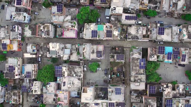 Aerial view of solar panels installed on residential rooftops in a neighborhood in Lucknow, Uttar Pradesh, India.