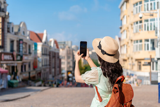 Happy young Asian woman tourist enjoying travel vacation and city exploration
