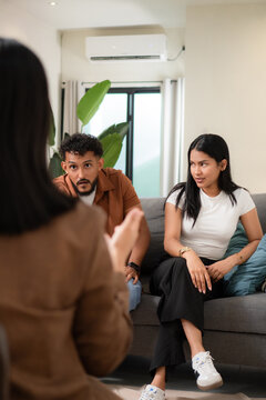 Young couple receiving support discussing problems with therapist