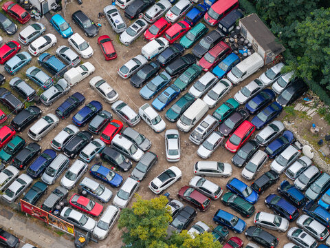Aerial view of a crowded parking lot filled with numerous cars parked in rows on an asphalt surface in Berlin, Berlin, Germany.