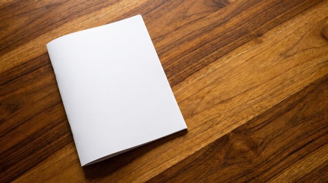 Blank white brochure booklet mockup lying on warm textured wooden surface