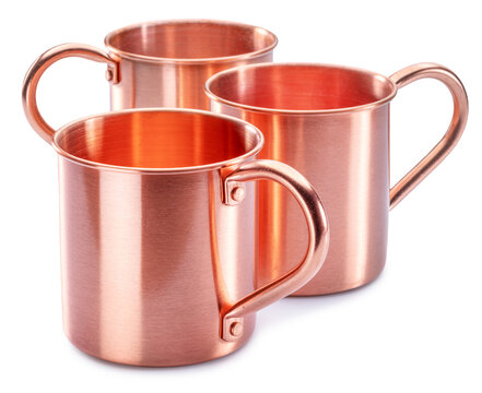 Set of three copper cups for moscow mule or ayurvedic copper water on white background. Clipping paths.